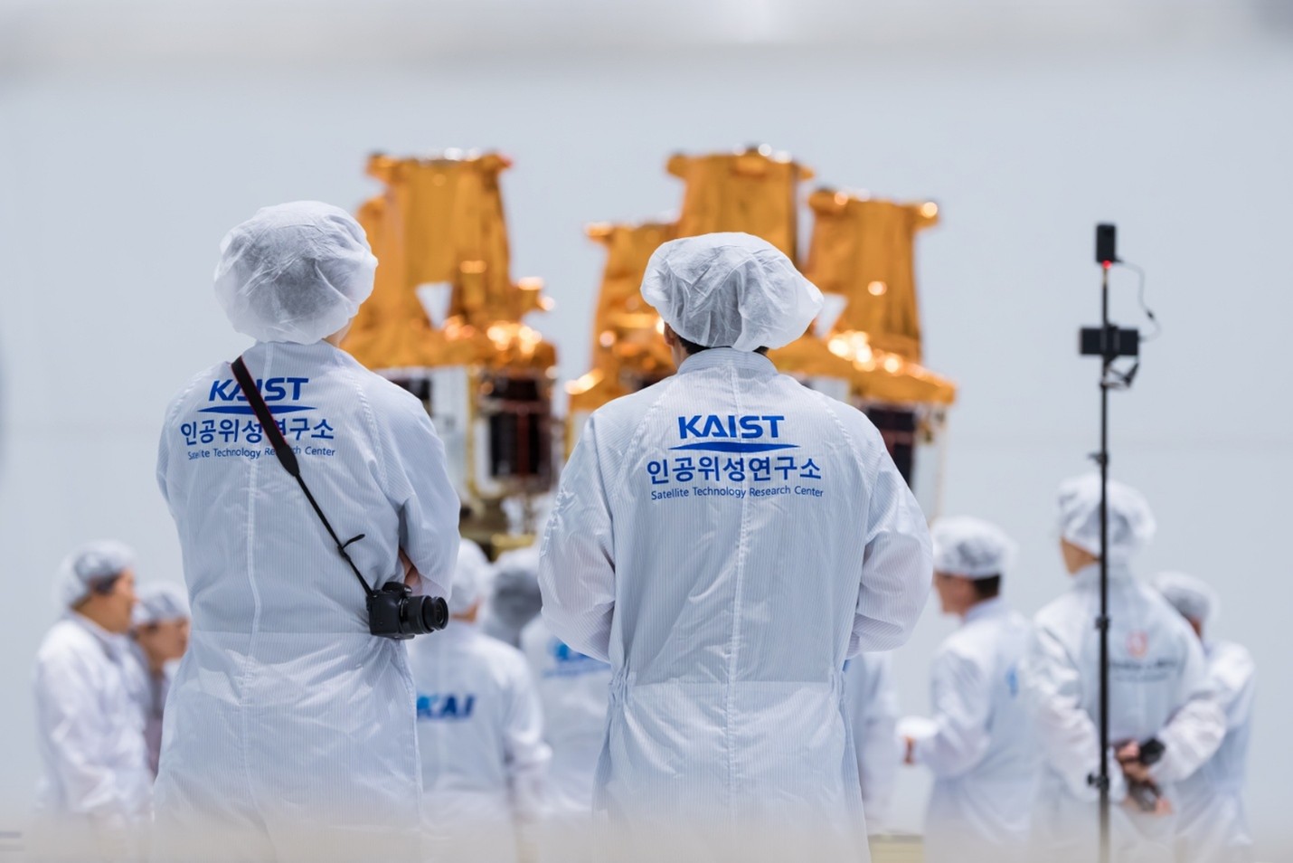 Figure 3. Researchers conducting final inspections of the five NEONSAT satellites mounted on the Nuri launch vehicle for its fifth launch (Courtesy of the Korea Aerospace Research Institute) Figure 3. Researchers conducting final inspections of the five NEONSAT satellites mounted on the Nuri launch vehicle for its fifth launch (Courtesy of the Korea Aerospace Research Institute)